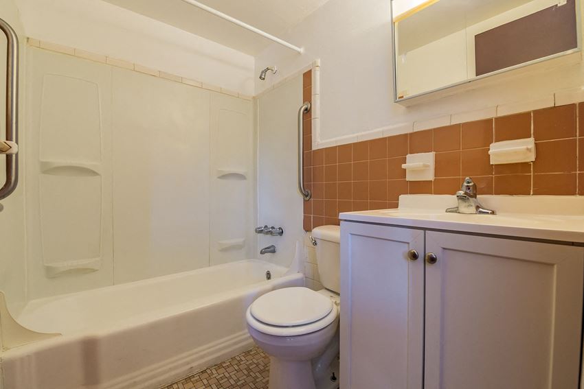 a bathroom with a sink toilet and a bath tub