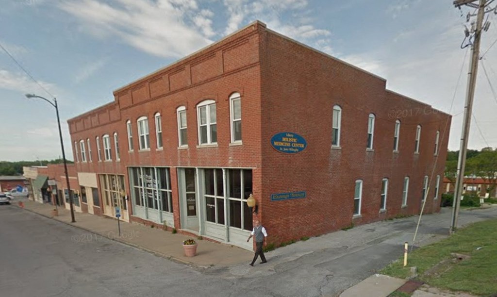 a red brick building on the corner of a street