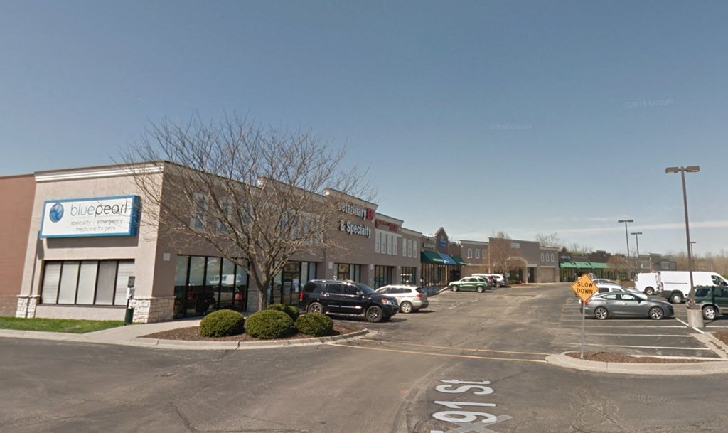 A parking lot in front of a Blue Pearl dental office.