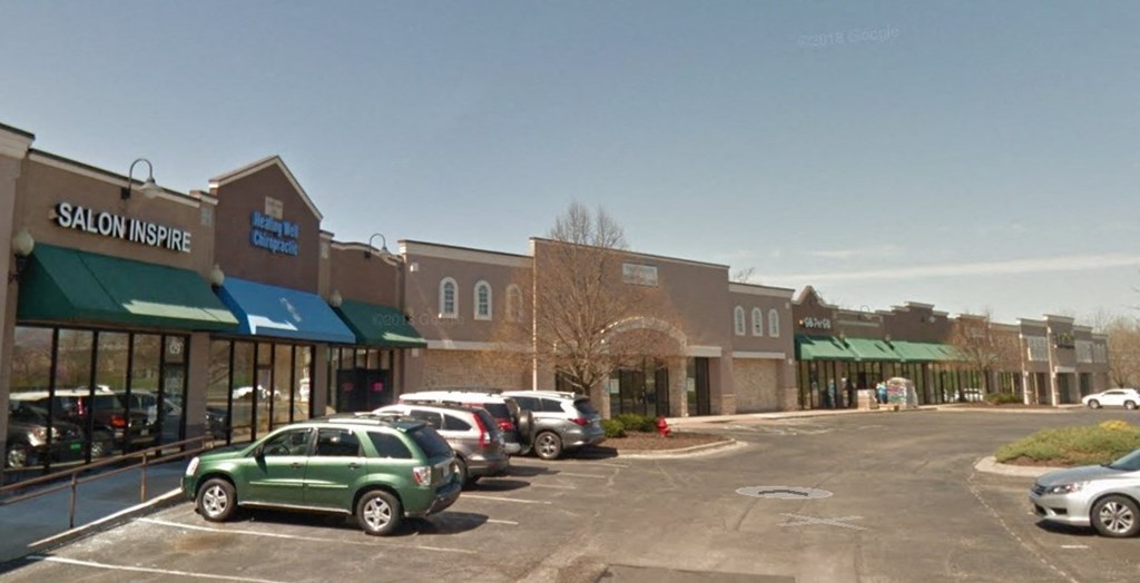 A parking lot in front of a Salon Inspire.