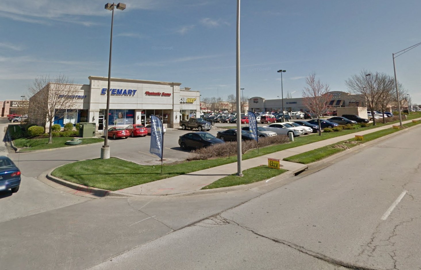a parking lot with cars parked in front of a store