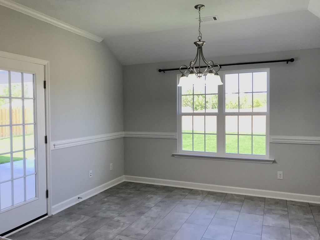 an empty living room with a window and a door