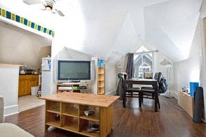 A living room with a television and a chair.