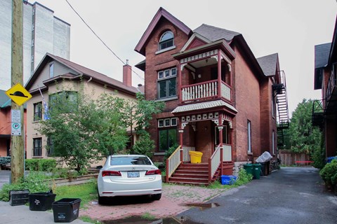 A car is parked in front of a house.