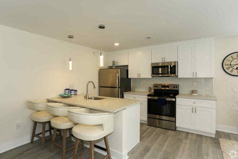 a kitchen with a center island and bar stools