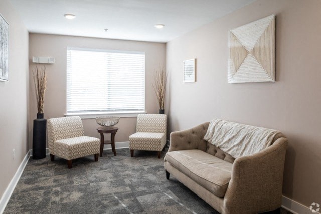 a living room with a couch and two chairs