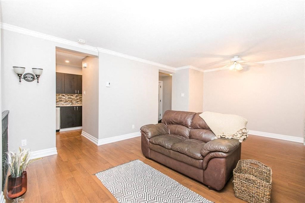a living room with a leather couch and a rug