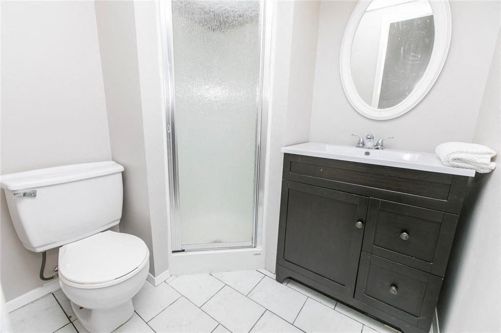 a bathroom with a toilet and a sink and a shower