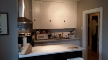 a kitchen with white cabinets and a white counter top
