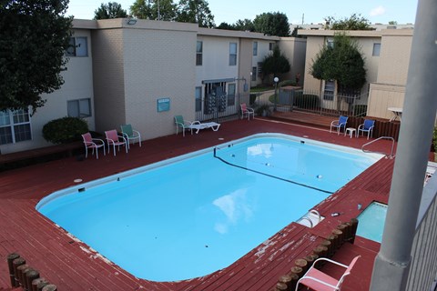 A small pool with red brick around it.