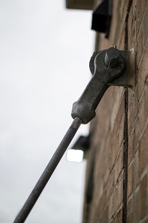 a tool sticking out of the side of a brick building