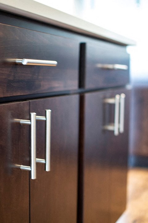 a kitchen with wooden cabinets and a refrigerator