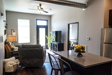 a living room with a kitchen and a dining table