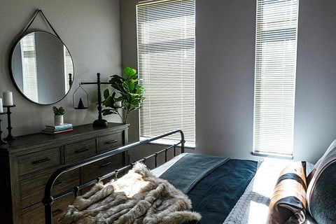 a bedroom with a bed and a mirror