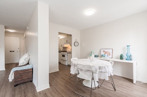 a dining room with a white table and chairs
