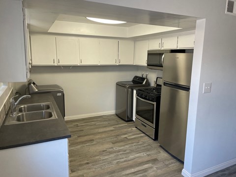 a kitchen with stainless steel appliances and a stainless steel sink