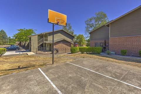 a basketball hoop in a parking lot in front of a building