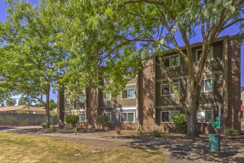an apartment building with trees in front of it