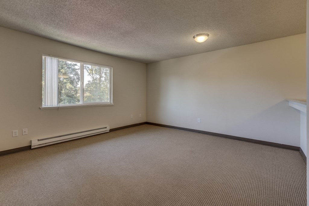 the living room of an empty house with a window