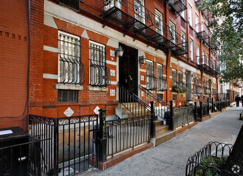 a red brick building with stairs in front of it
