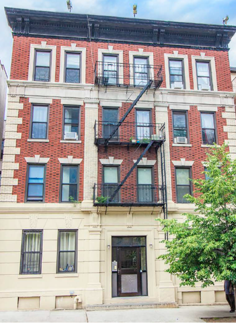 A red brick building with a black fire escape.