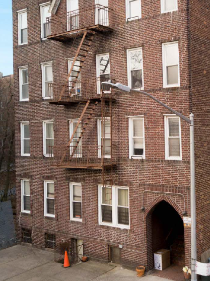 a red brick building with a fire escape