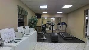 A room with a treadmill, exercise bike, and other workout equipment.