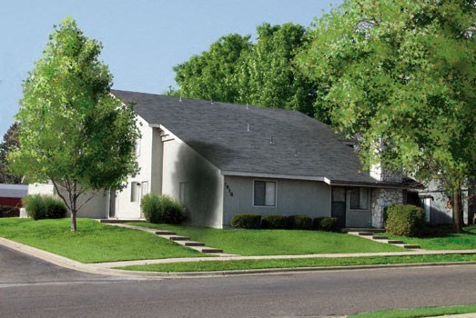 a white house with a gray roof on a street