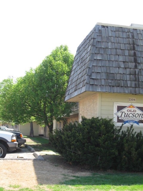 a building with a sign and a truck parked in front of it