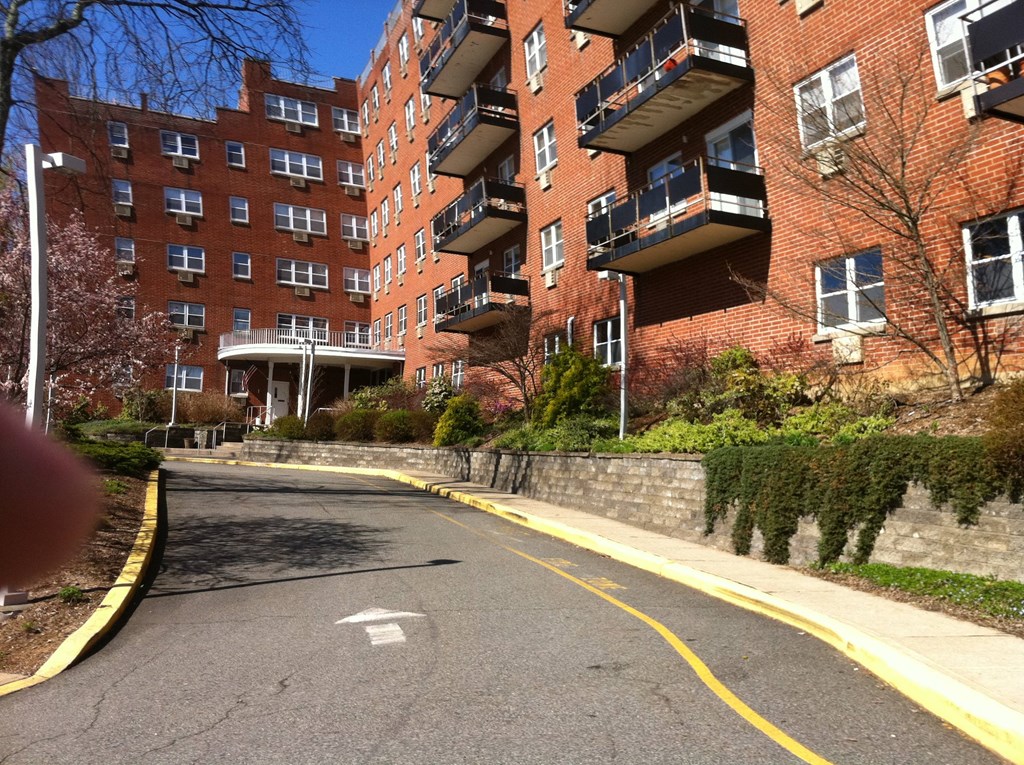 an empty street in front of a brick building