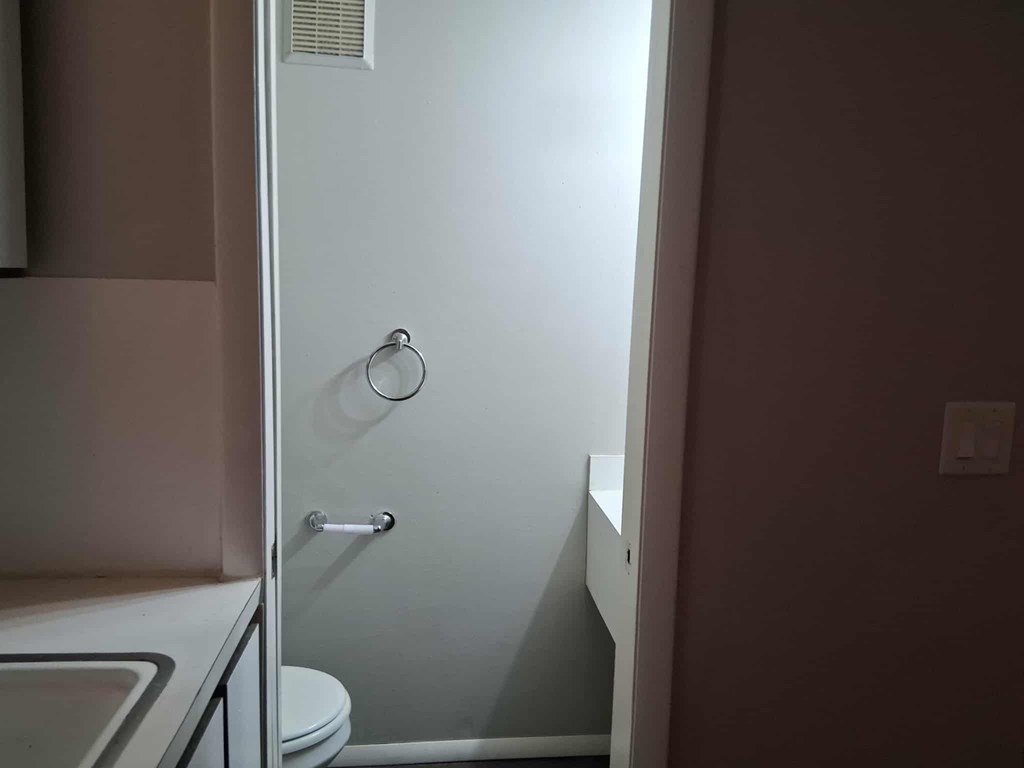A white shower stall with a glass door and a silver handle.