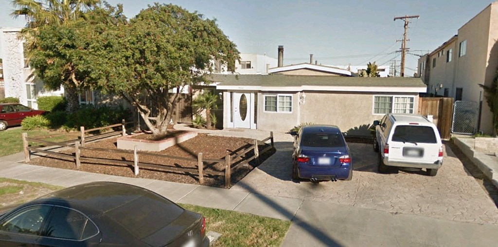 A car is parked in front of a house.