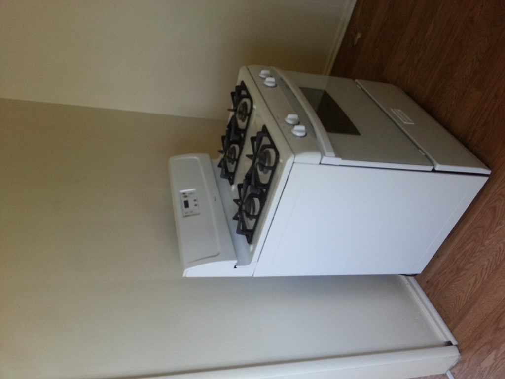a white microwave oven sitting on top of a drawer