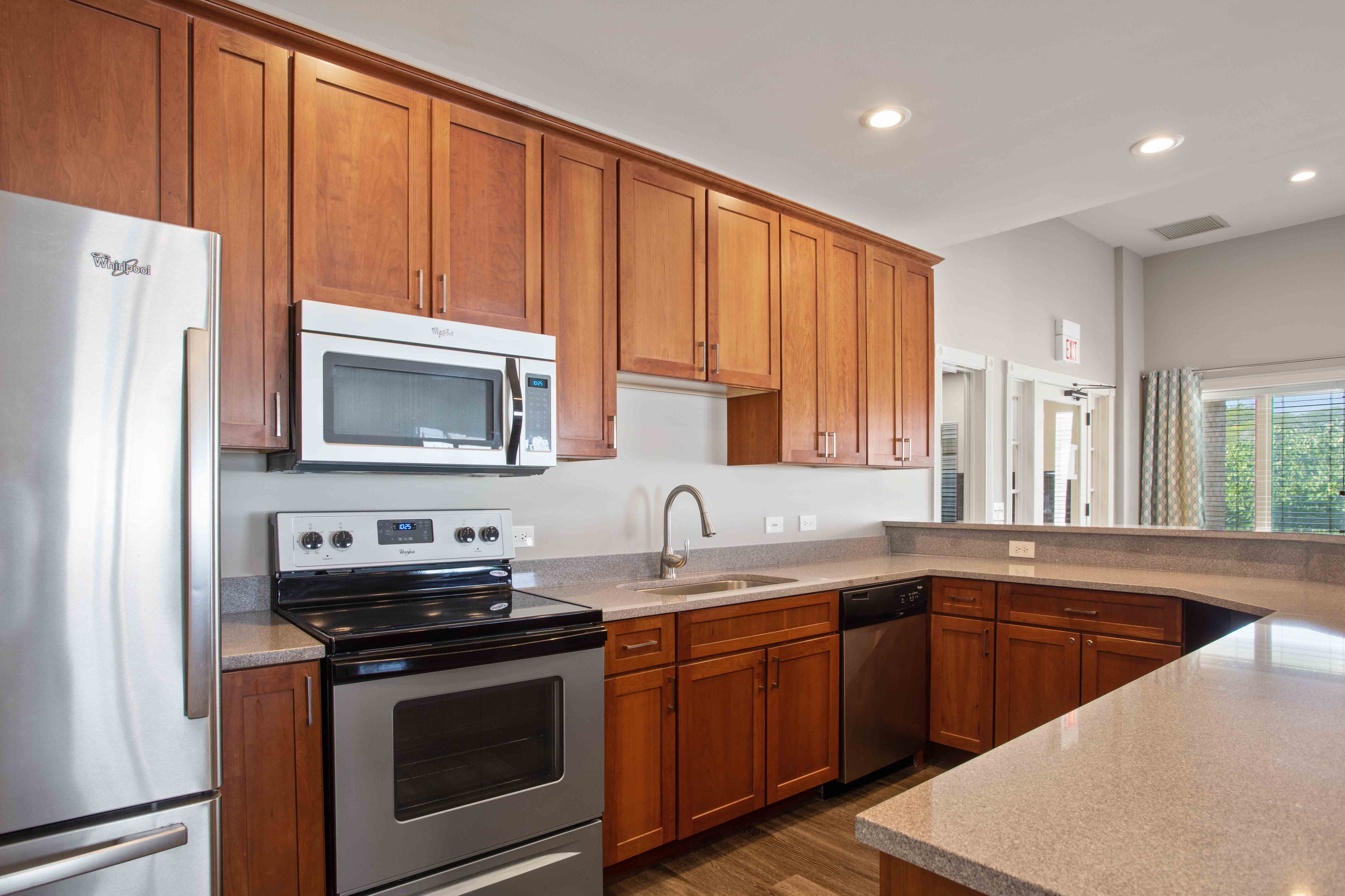 A kitchen with wooden cabinets and stainless steel appliances.