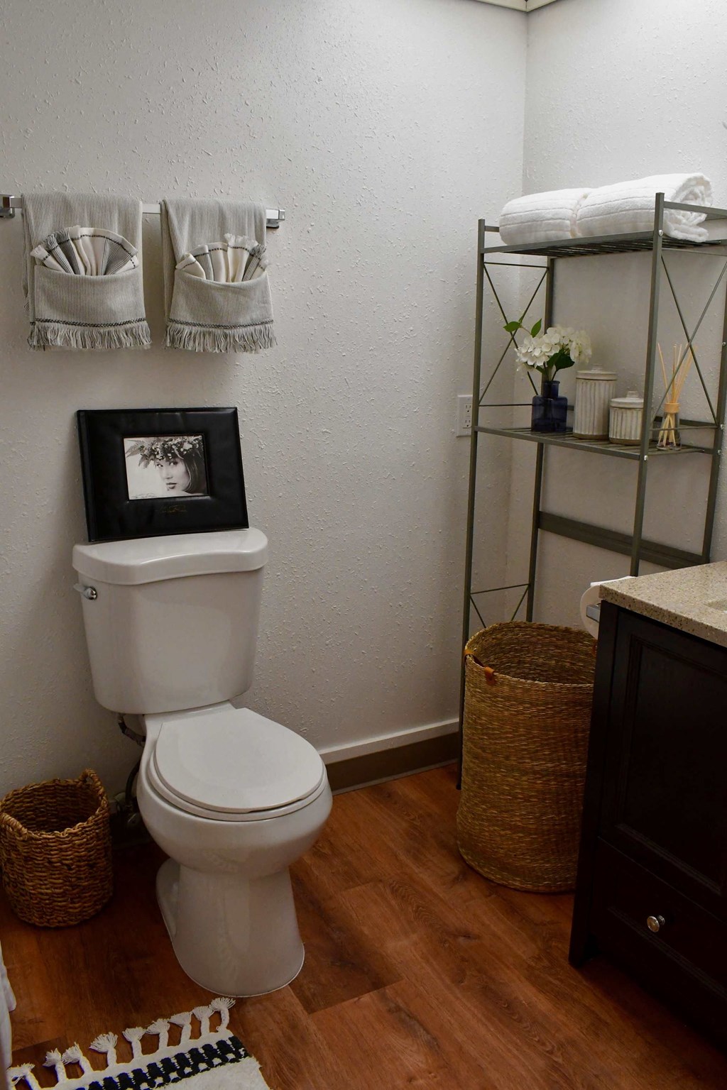 a bathroom with a toilet and a shelf with towels