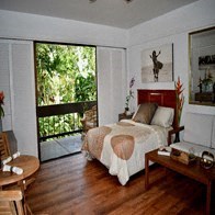 a bedroom with a bed and a sliding glass door