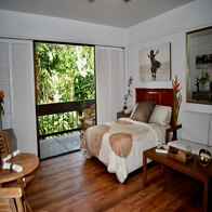 a bedroom with a bed and a sliding glass door