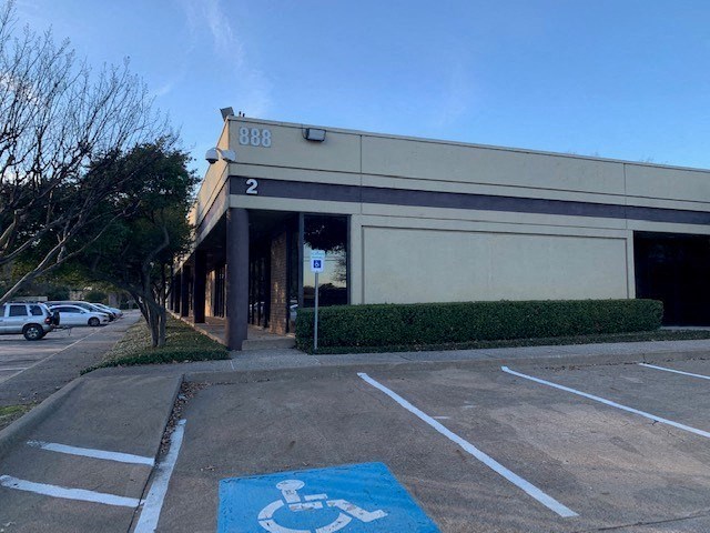 a building with a handicapped sign in a parking lot