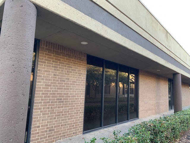 a brick building with a large glass window