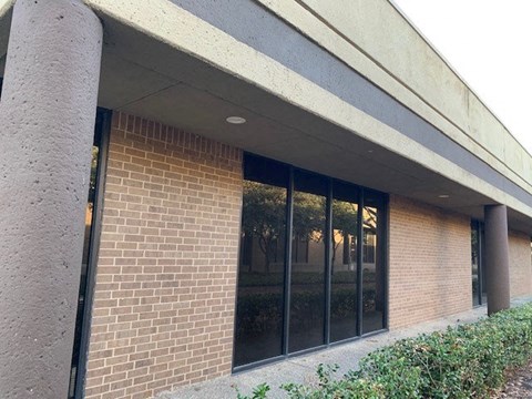 a brick building with a large glass window