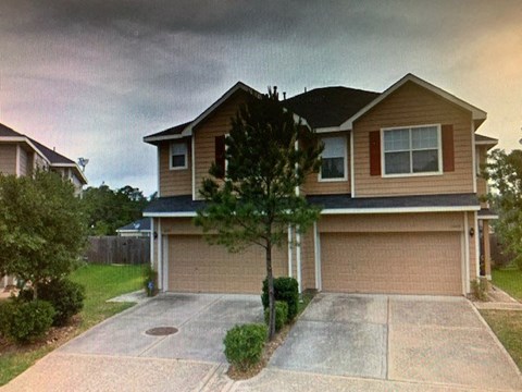A house with a brown garage door and a driveway.