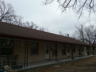 the front of a brick house with a porch