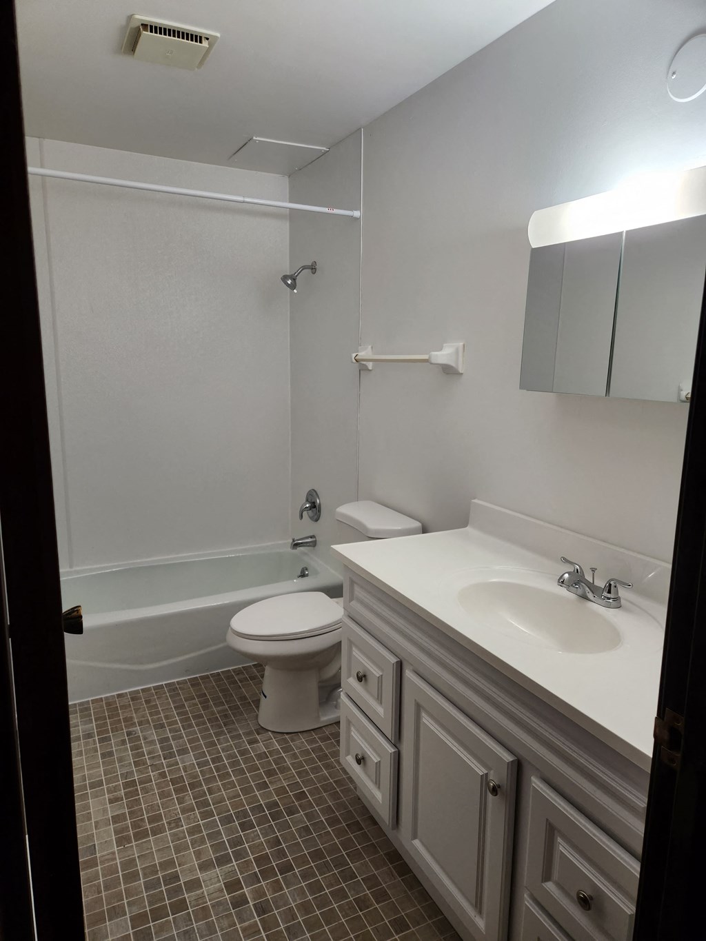 a white bathroom with a sink toilet and shower