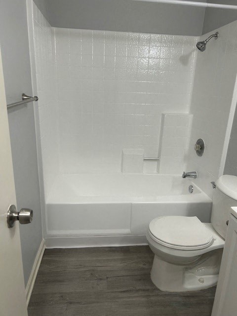 A white bathroom with a toilet, tub, and shower.