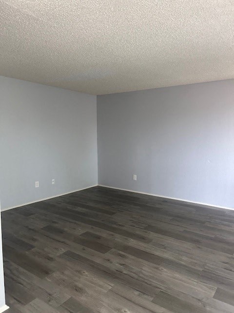 A room with a wooden floor and white walls.