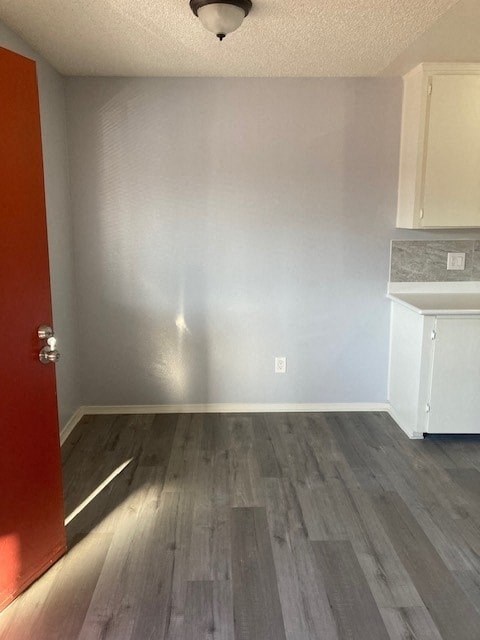 A room with a red door and a white cabinet.