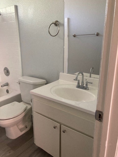 A white toilet sits next to a sink in a small bathroom.