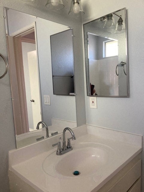 A bathroom sink with a mirror above it.