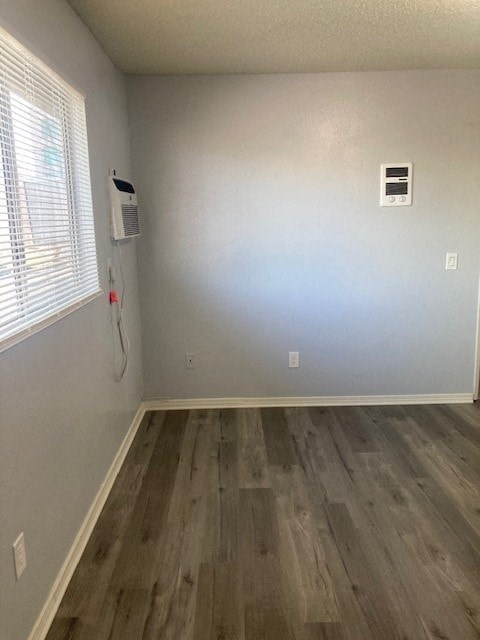 A room with a window and a wall-mounted air conditioner unit.