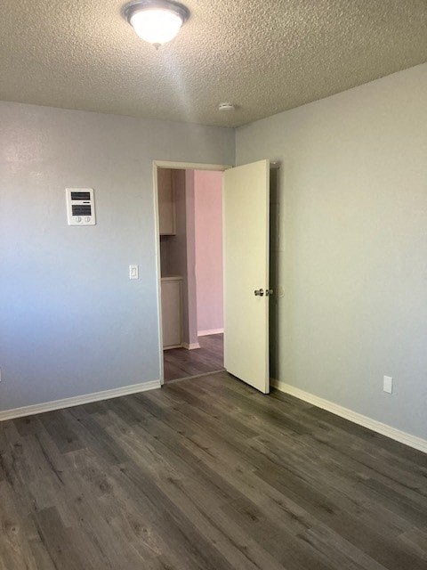 A room with a white door and a grey wall.